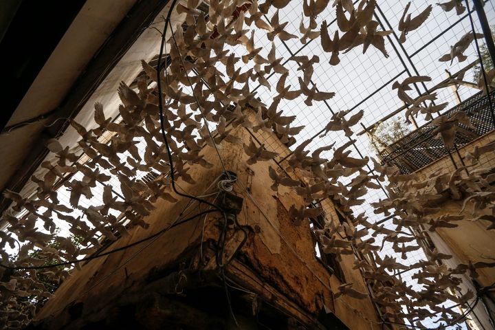 Art installation using ceramic doves in an alley in old Damascus, as part of an exhibition titled "Once upon a time..." (LOUAI BESHARA / AFP)