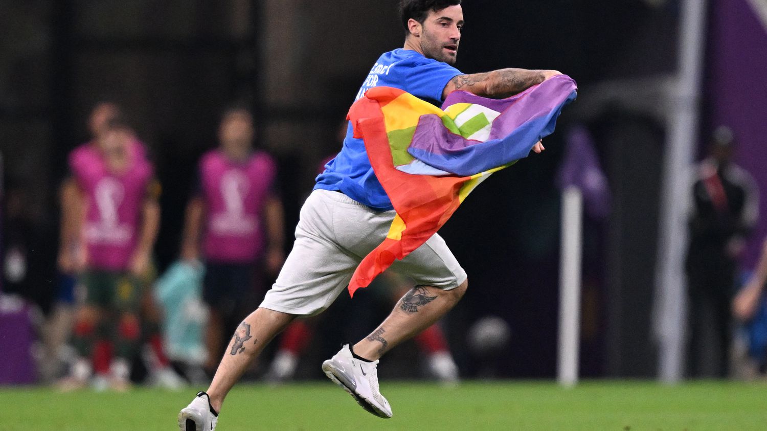 World Cup 2022: a man with a rainbow flag enters the pitch during the match Portugal-Uruguay
