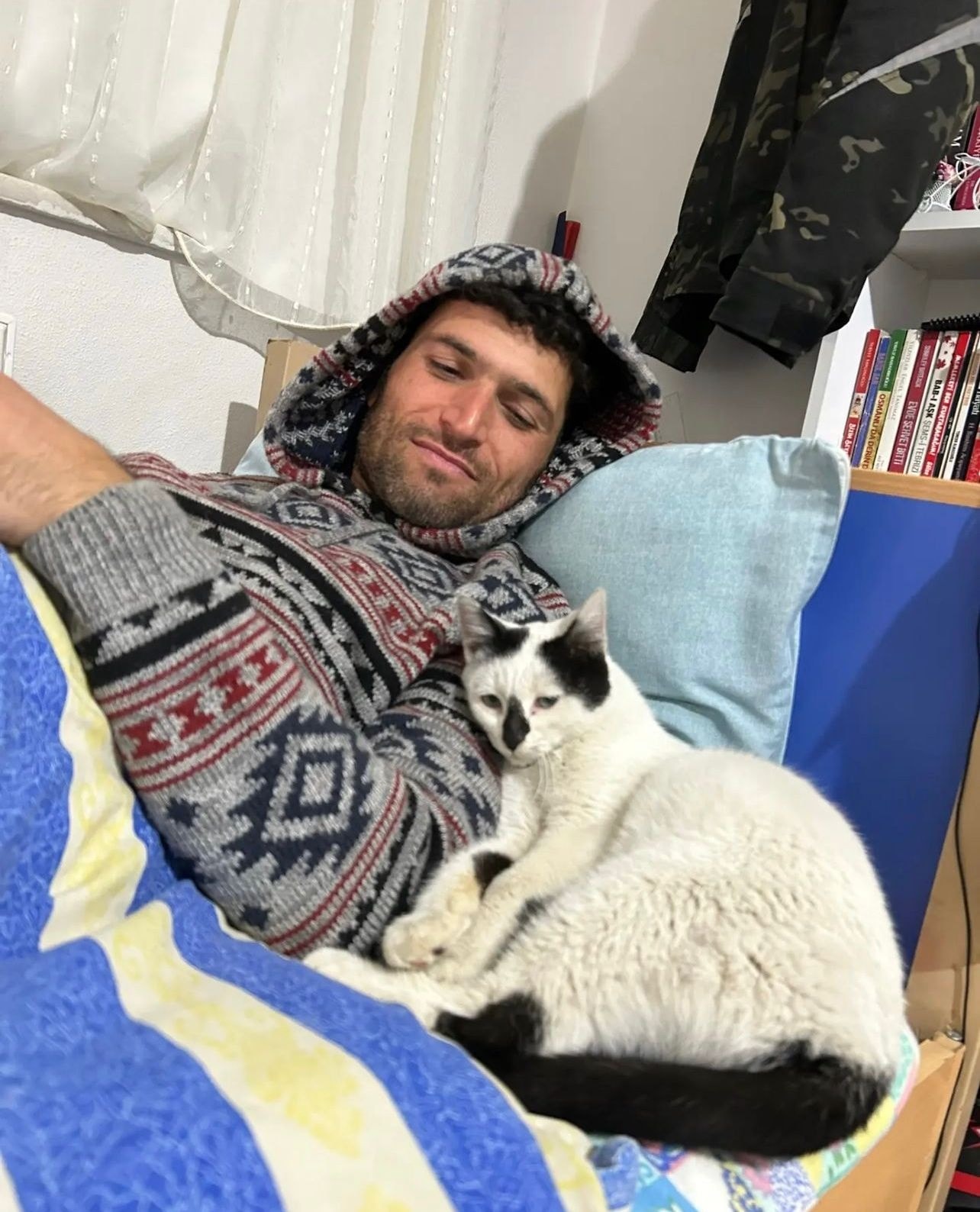 May be an image of 1 person, cat and indoor