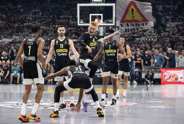 James Nunnally and Yam Madar greet each other surrounded by their teammates before the game against Olympiacos.