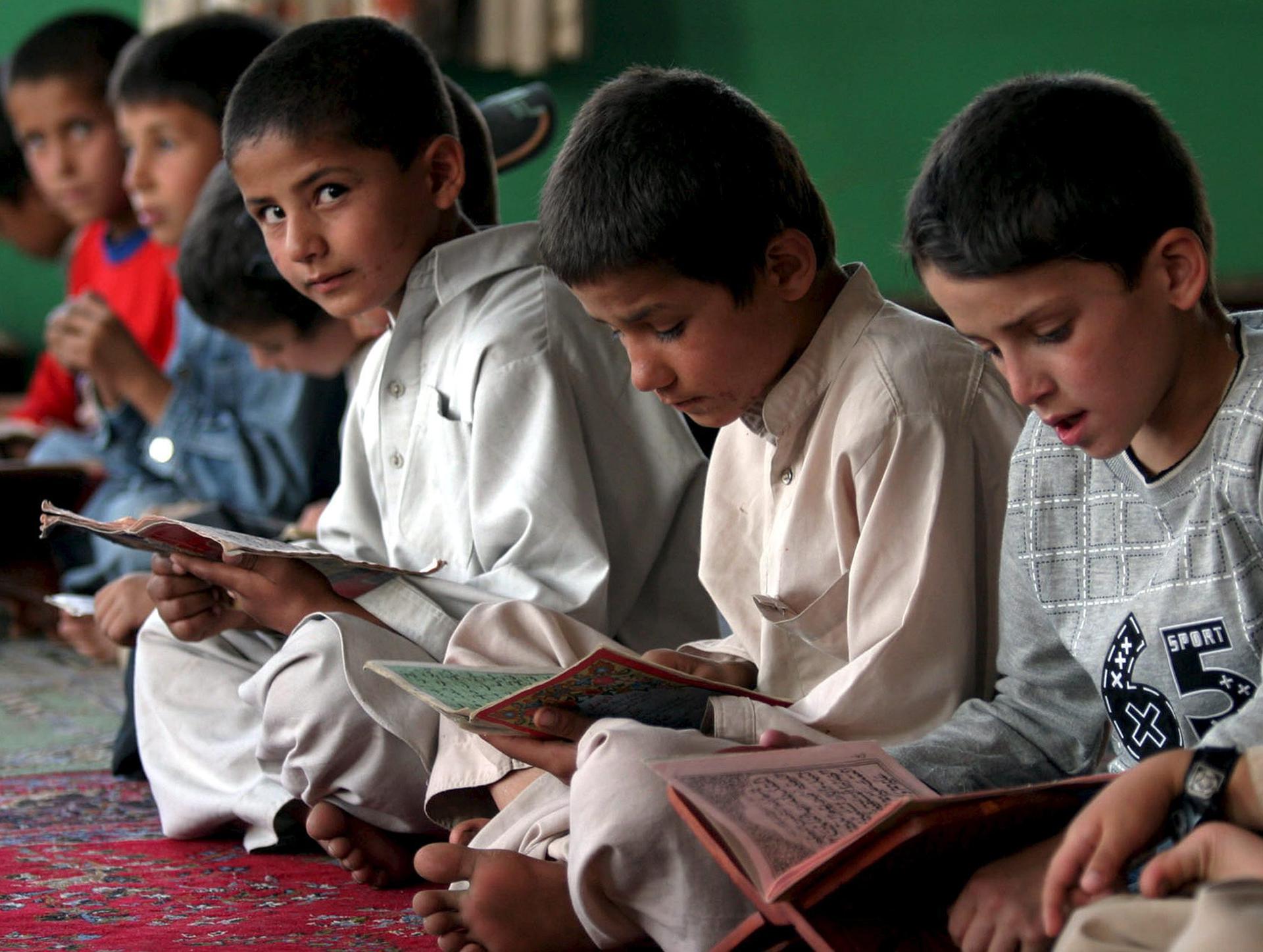 File photo of Afghan children reading the Koran at a school in Kabul.