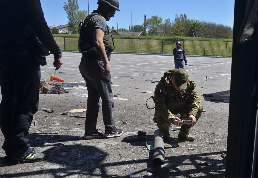 Ukrainian soldiers inspect the damage caused by a Russian attack, in a file image. 