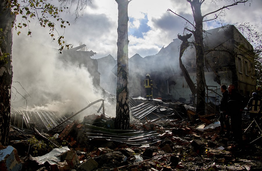 Ukrainian rescuers work to extinguish a fire among the rubble of a small factory damaged during shelling in Kharkov