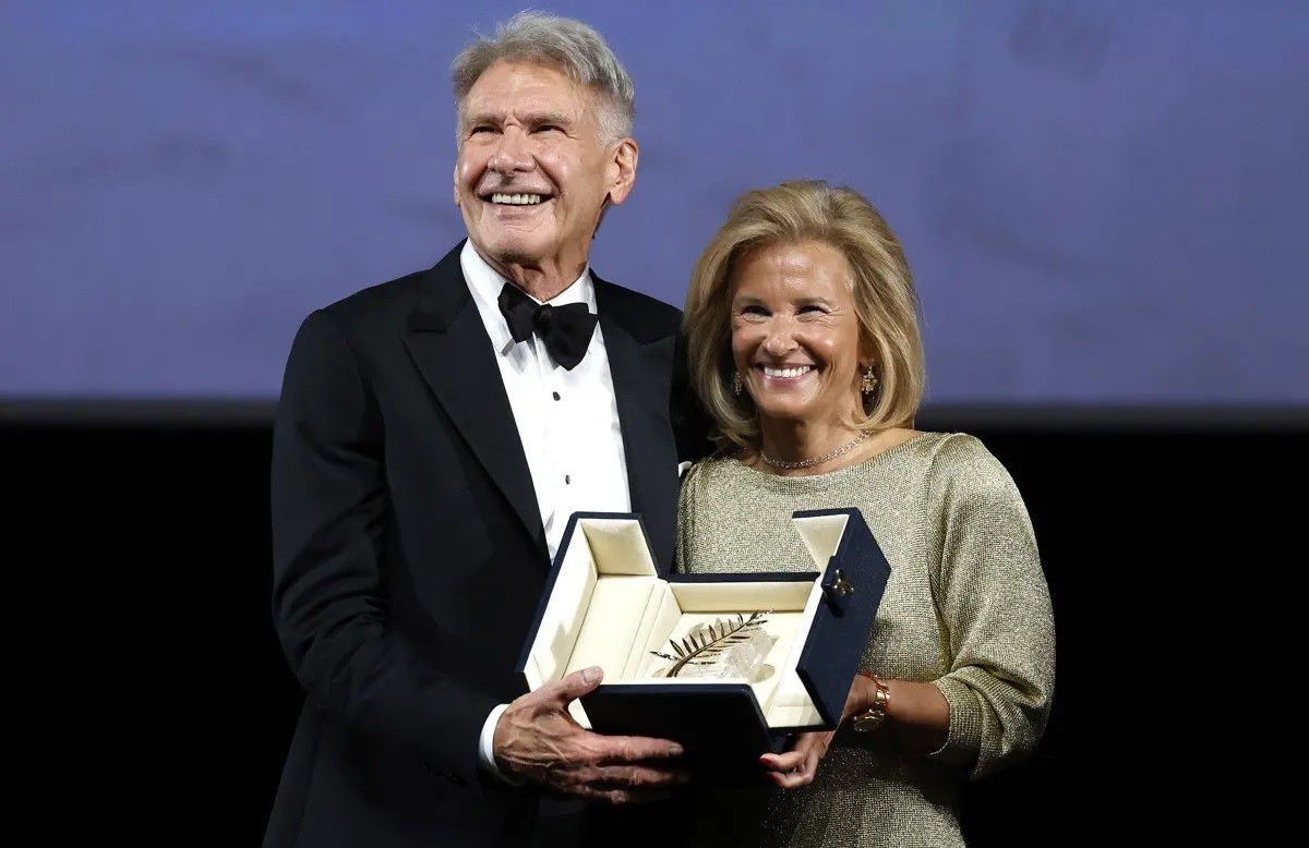 Harrison Ford receives the honorary Palme d'Or from the President of the Cannes International Film Festival, Iris Knobloch.