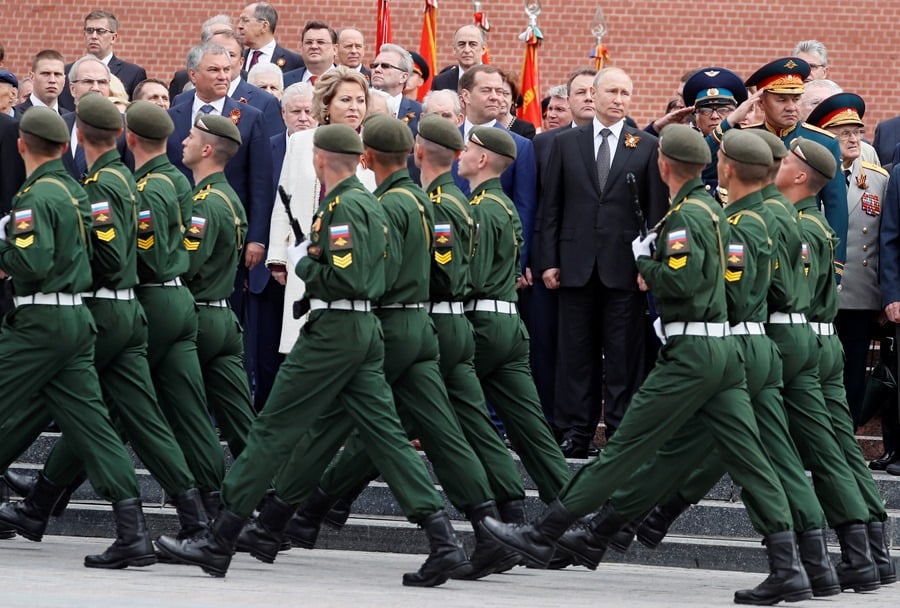 File image of Russian President Vladimir Putin (c-right), Defense Minister Sergei Shoigu (right), and former Prime Minister Dmitry Medvedev (3-right), at a military parade in Moscow