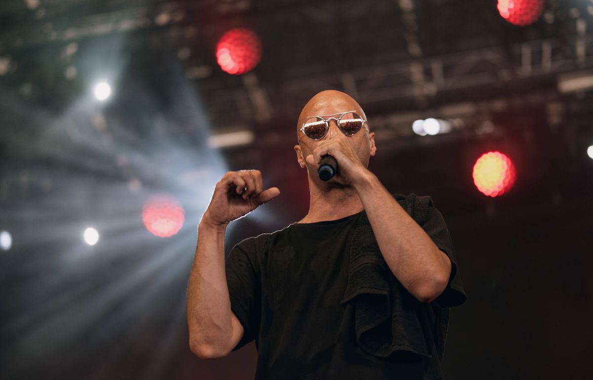 Rapper Alkpote throws joints to his audience at a festival
