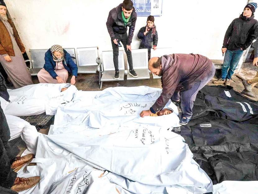 Palestinians cover their dead in the Nasser sanatorium, which is no longer a safe place.