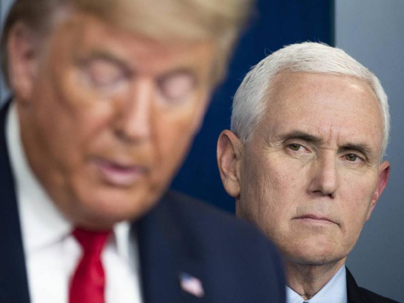 Mike Pence, Vice President of the United States, looks at Donald Trump.