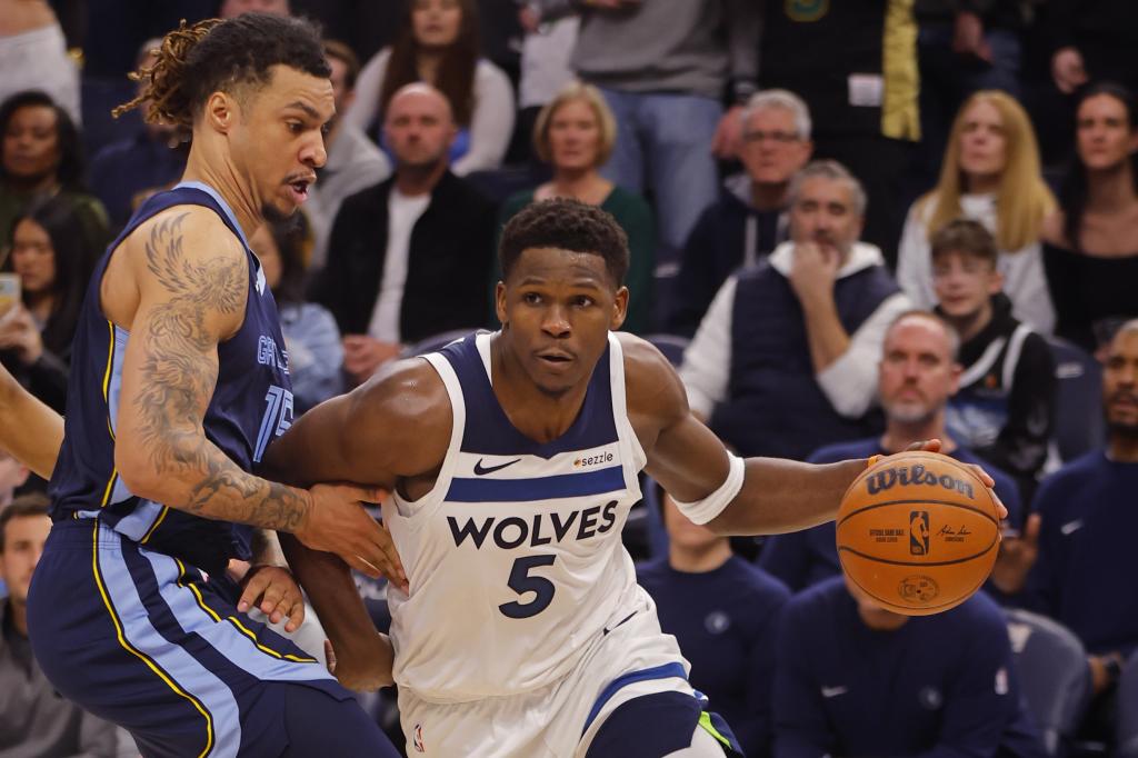 Anthony Edwards tries to overcome Brandon Clarke's defense.