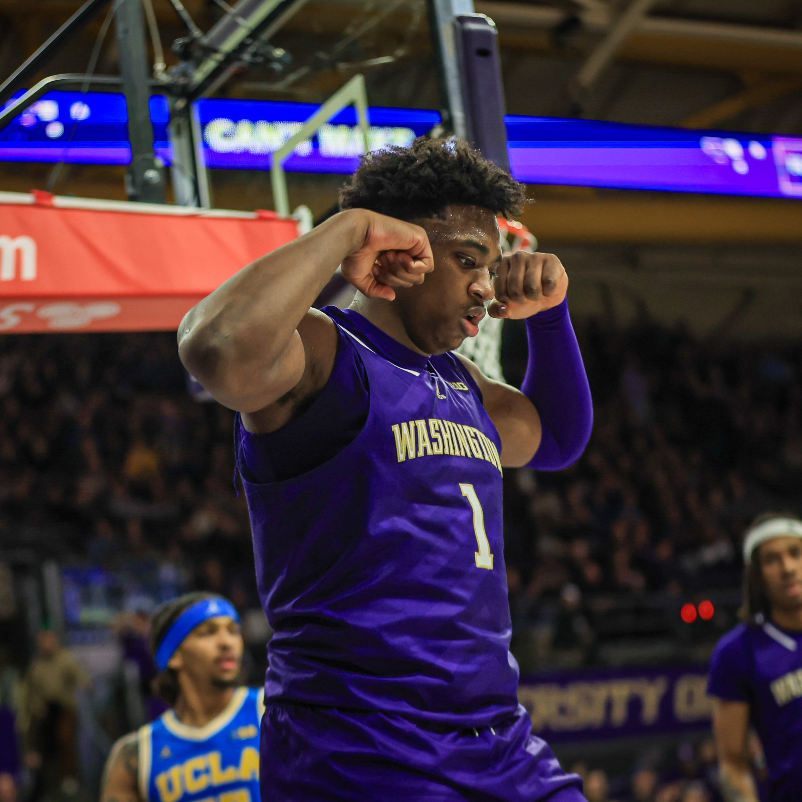 Great Osobor flexes his muscles to celebrate a Huskies basket.