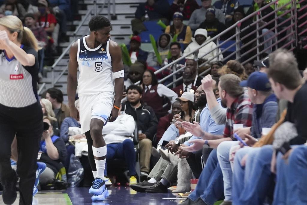 Minnesota Timberwolves guard Anthony Edwards (5) reacts to courtside attendees after making a 3-point basket in the second half of an NBA basketball game in New Orleans, Tuesday, Jan. 7, 2025. The Timberwolves won 104-97. (AP Photo/Gerald Herbert)