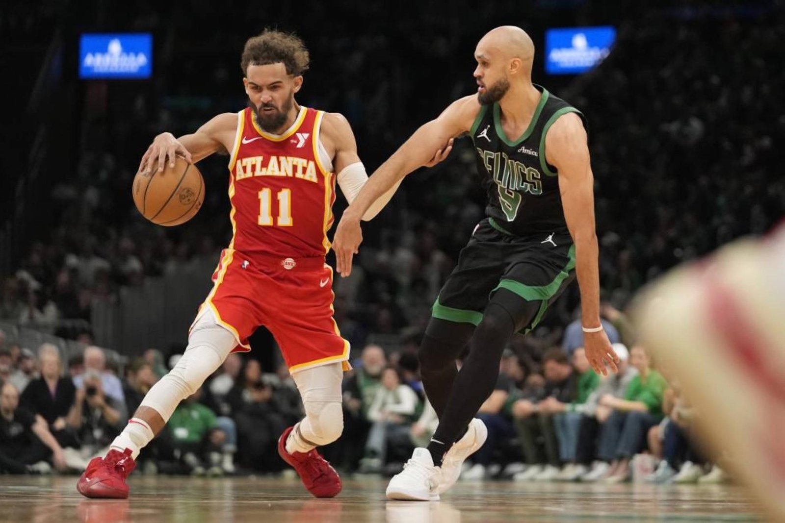 Trae Young tries to overcome Derrick White's defense.