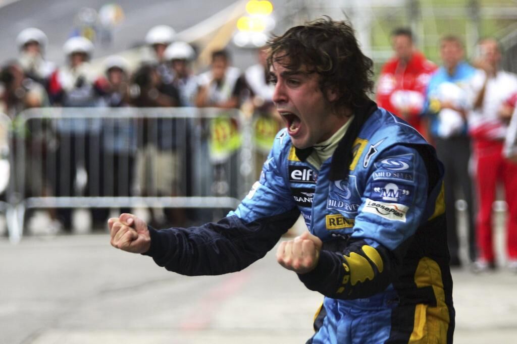 Fernando Alonso celebrates the 2005 World Cup on his Renault.
