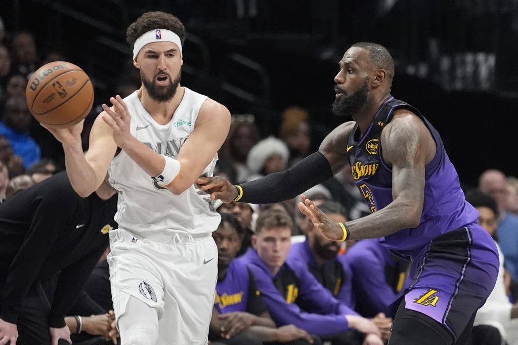 Dallas Mavericks guard Klay Thompson, left, passes the ball against Los Angeles Lakers forward LeBron James (23) during the second half of an NBA basketball game Tuesday, Jan. 7, 2025, in Dallas. (AP Photo/LM Otero)
