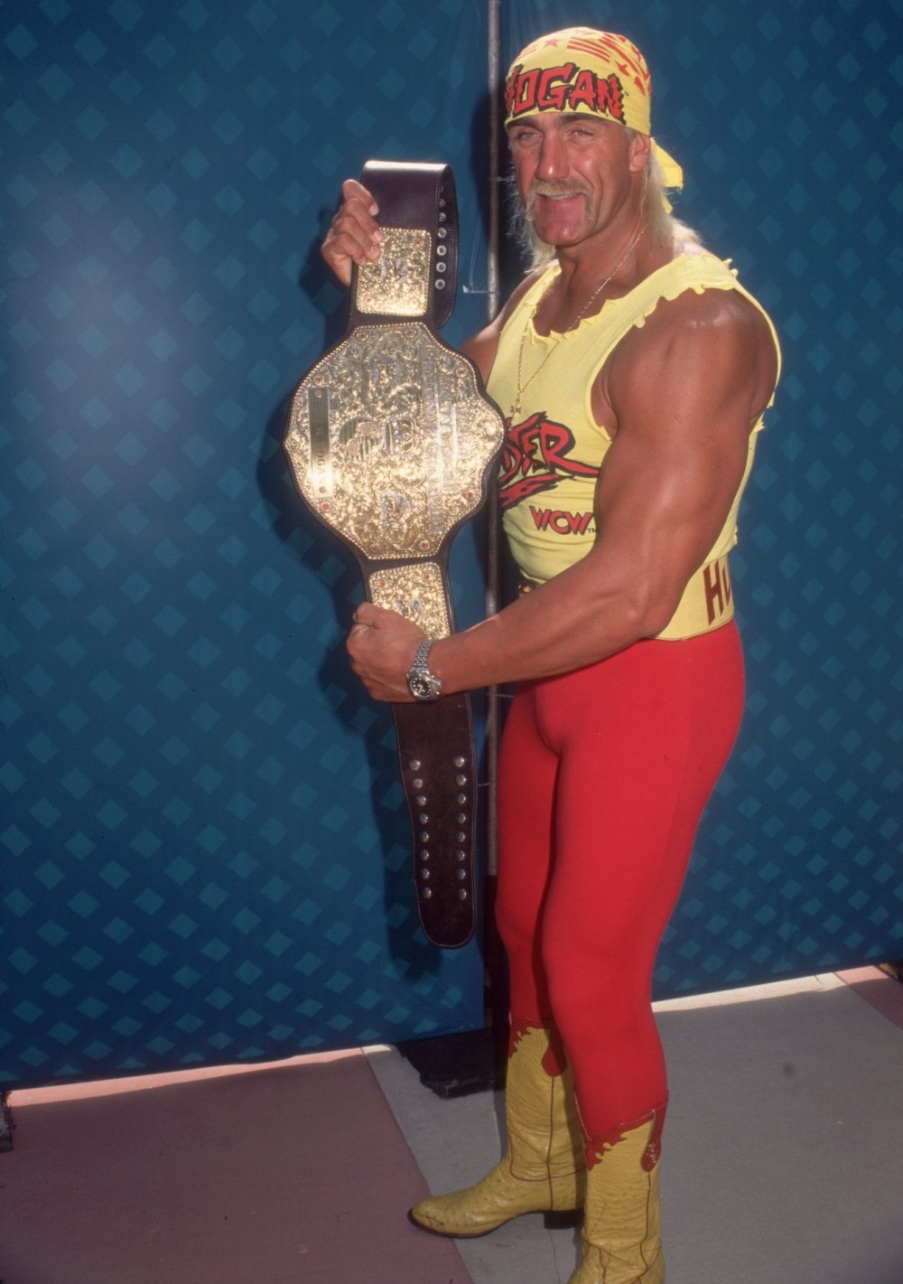 WWE Hall of Famer Hulk Hogan Dies at 71 Hulk Hogan stands with arms crossed, looking at the camera.