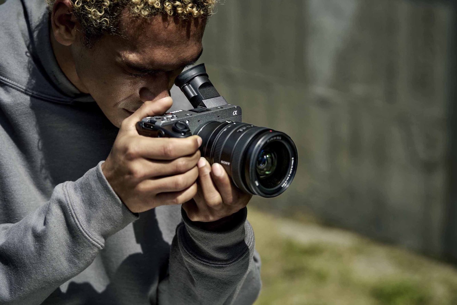 Sony FX2 camera with an attached lens and XLR handle, seen from the top-front.