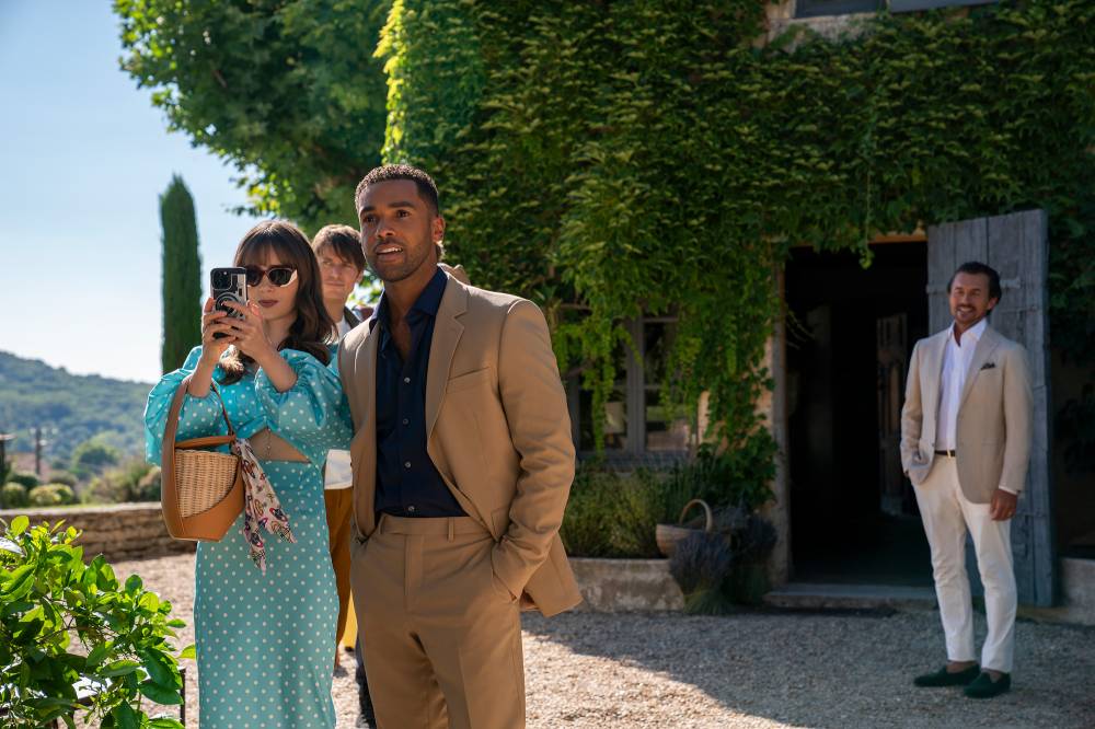 Emily in Paris Season 5: December Release, Key Cast Changes, Gabriel Love Triangle Emily Cooper in a stylish outfit, walking with a dog on a Parisian street.