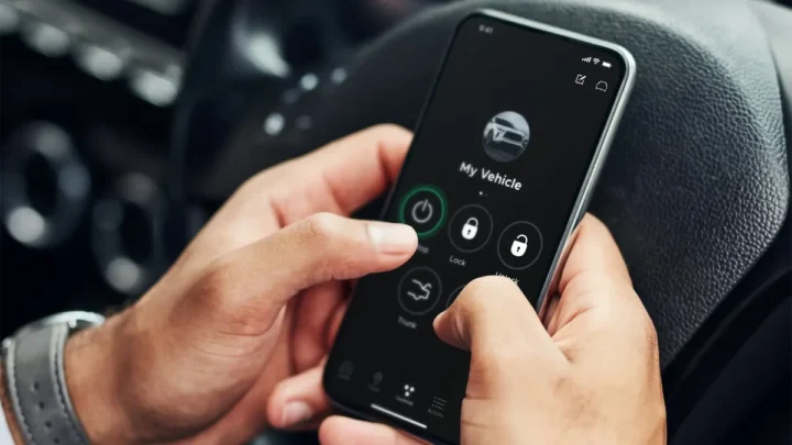 A car's dashboard with various warnings and messages displayed on the screen, indicating system activity.