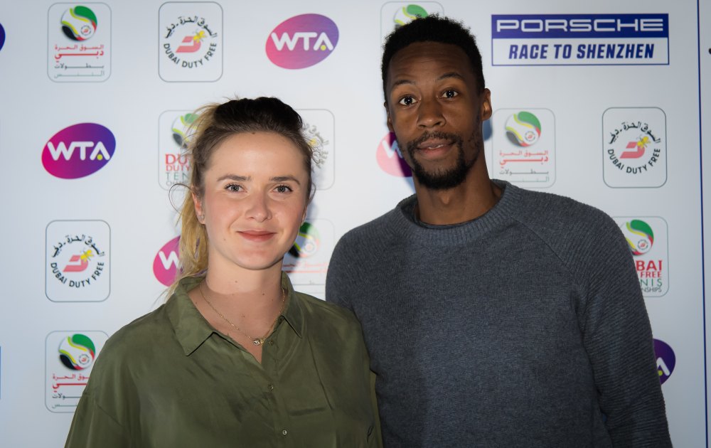 Ukrainian tennis player Elina Svitolina and French tennis player Gael Monfils pose on a red carpet.