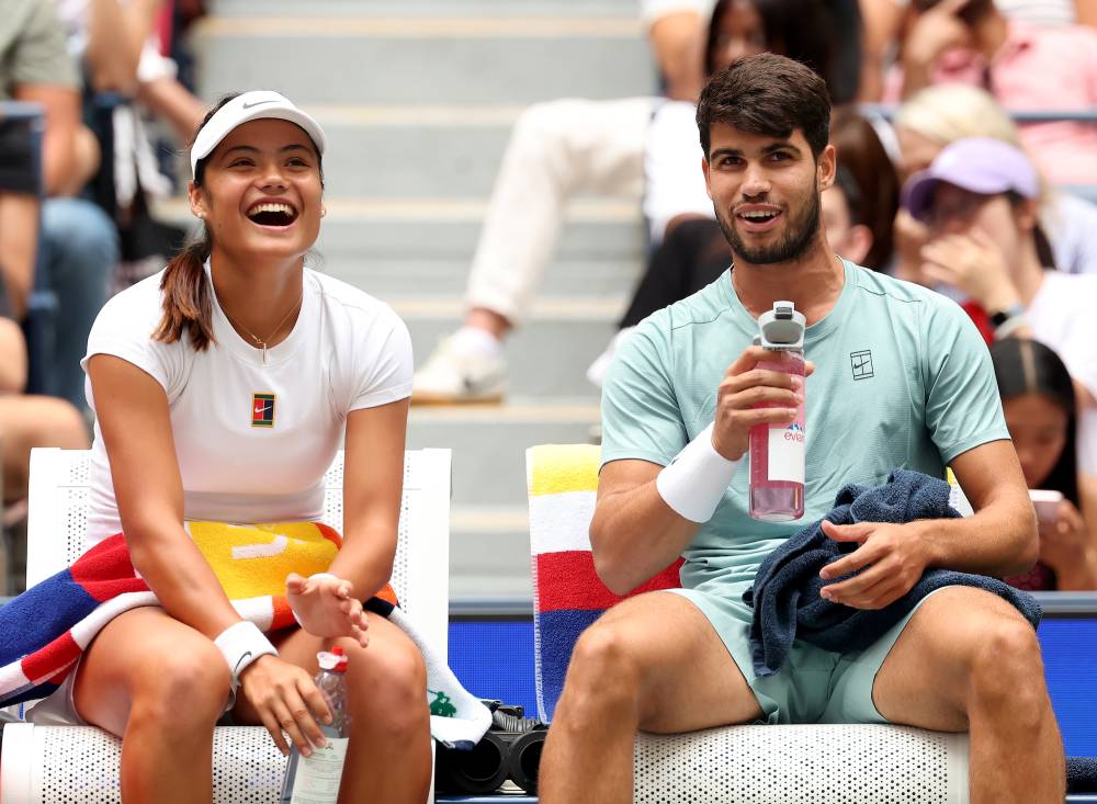 Carlos Alcaraz and Emma Raducanu share a laugh on the court.