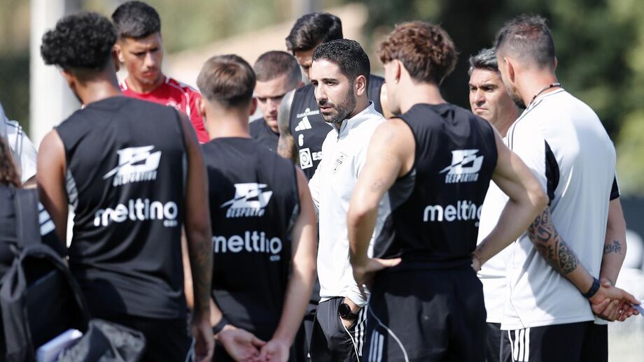 João Pereira speaks to the squad during a training session