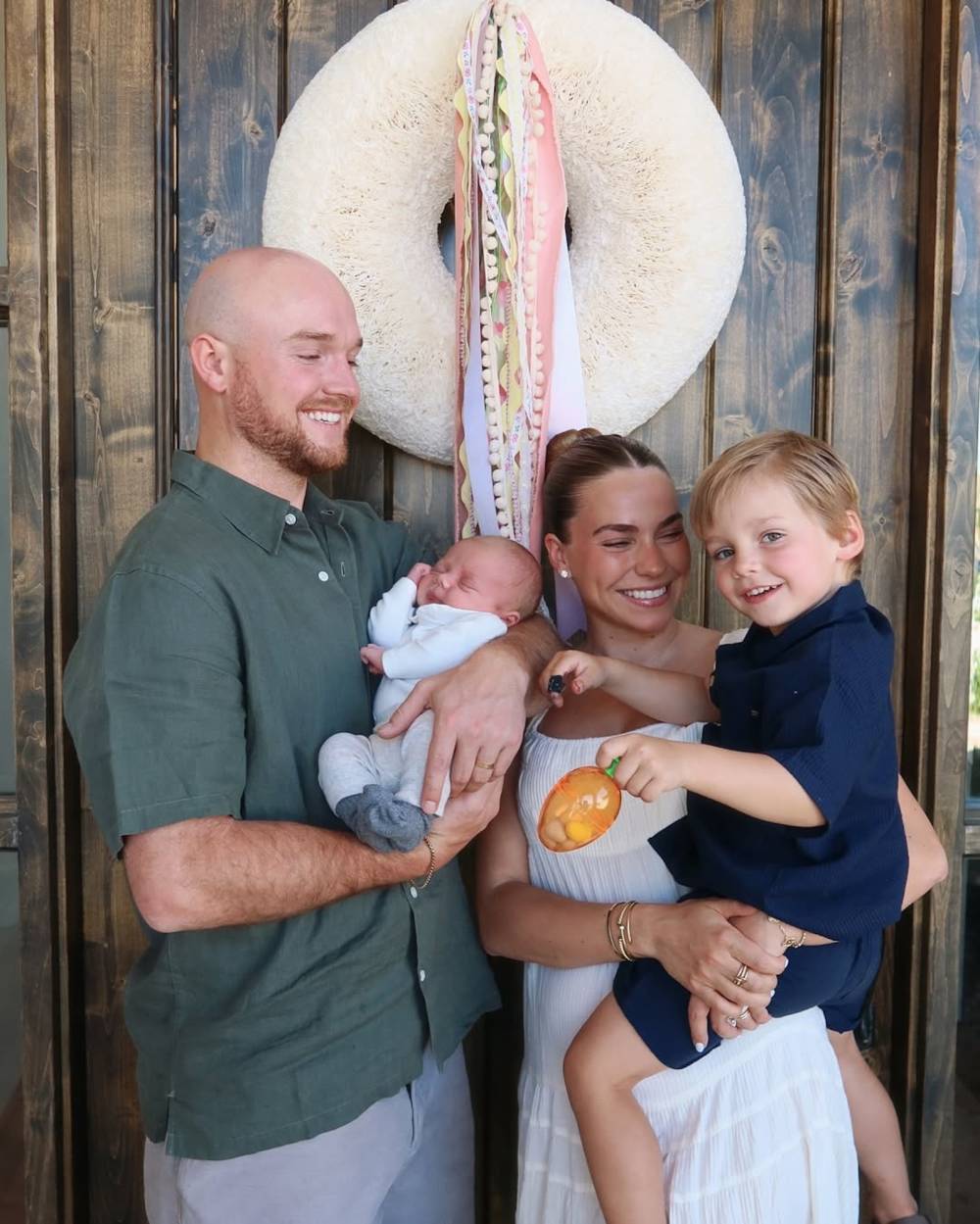 Emilie Kiser, Trigg Kiser, Teddy Kiser, and Brady Kiser smile for a family photo.