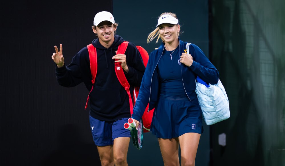 Australian tennis player Alex de Miñaur and British tennis player Katie Boulter walk onto the court.