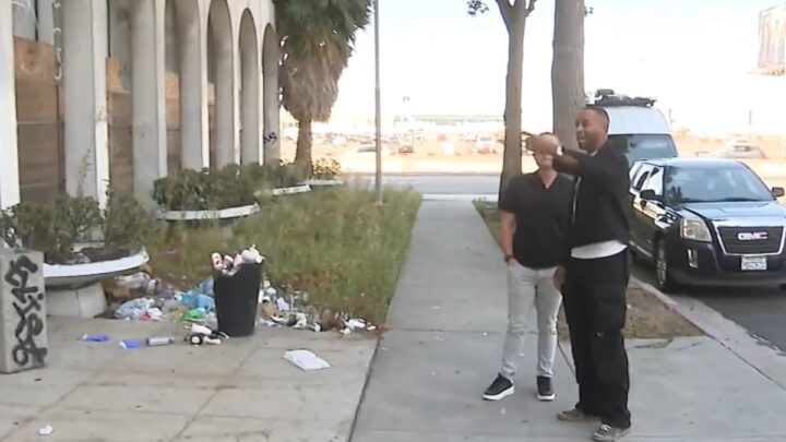AirTag Tracks Stolen Airport Luggage; Man Recovers Bag With Police Aid Daniel Scott and journalist Alex Rozier outside the building where the luggage was found.