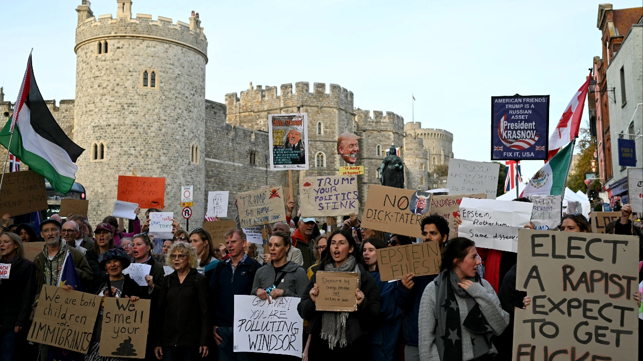 Protesters gathered outside Windsor Castle, holding signs saying "Trump not welcome".