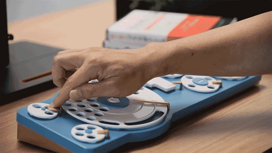 A person turns dial on a concept keyboard created by Google Japan.