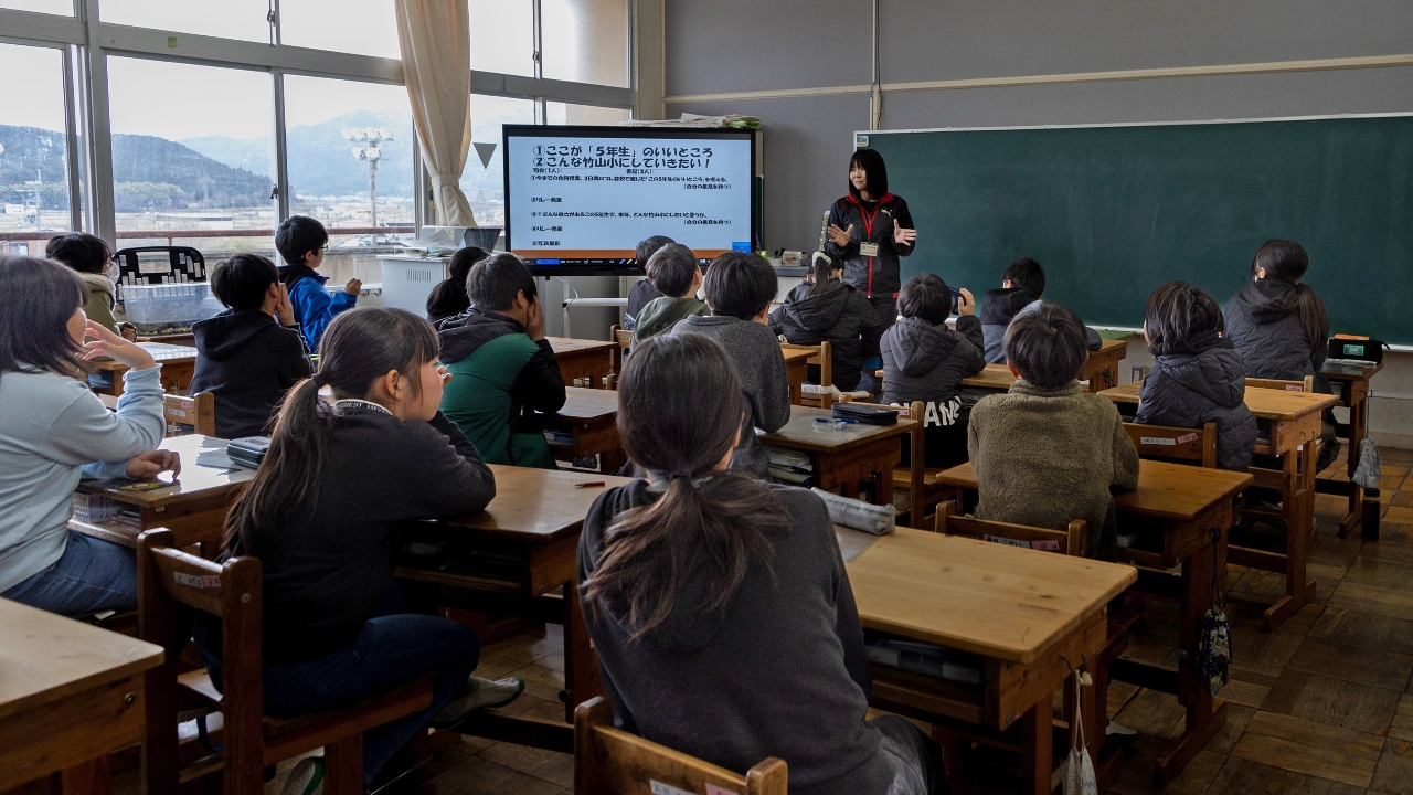 An image of a teacher in a classroom, symbolizing the demanding work schedules faced by educators.