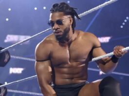 Trick Williams celebrating a championship victory at a professional wrestling stadium event.